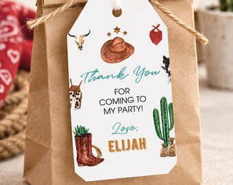 May include: A brown paper gift bag with a white rectangular tag tied with twine. The tag features watercolor illustrations of a cowboy hat, boots, cactus, and skull, with the text Thank You FOR COMING TO MY PARTY! Love, ELIJAH in black and orange.