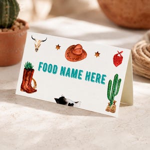 K&ouml;nnte beinhalten: Eine wei&szlig;e, gefaltete Tischkarte mit dem t&uuml;rkisfarbenen Text FOOD NAME HERE. Die Karte ist mit Aquarellillustrationen eines Kuhsch&auml;dels, eines braunen Cowboyhuts, eines roten Bandanas, eines braunen Stiefels mit Sukkulente, einer Katze und eines Kaktus verziert.