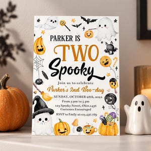 以下が含まれることがあります： ハロウィーンをテーマにしたイラスト（幽霊、カボチャ、コウモリ、キャンディなど）が描かれた白い長方形の招待状。テキストには「Parker is Two Spooky, Join us to celebrate Parker's 2nd Boo-day, Sunday, October 28th, 202x, 3 pm to 5 pm」と記載されています。