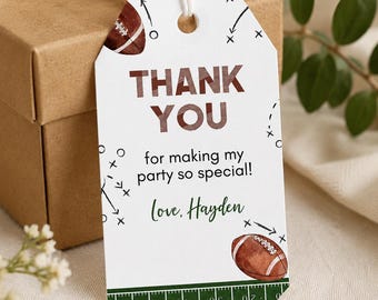 May include: A white rectangular gift tag with a hole at the top, featuring brown football illustrations, black play diagrams, and the text "THANK YOU for making my party so special! Love, Hayden" above a green football field yard line graphic.