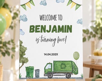 May include: A white rectangular sign on a wooden easel featuring green and yellow bunting, blue clouds, and a green recycling truck. The text reads: WELCOME TO BENJAMIN is turning five! 14.04.202X. The design includes a green trash bin and a balloon.