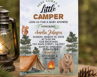 May include: A baby shower invitation card featuring a woodland theme with a brown tent, a campfire, a squirrel, and a bear. The text reads: Here Comes A Little Camper, Join Us For A Baby Shower Honoring Amelia Johnson, Sunday, March 12, 202X.