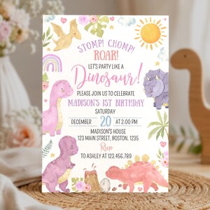 May include: A rectangular birthday invitation card featuring watercolor illustrations of colorful dinosaurs, a sun, clouds, and flowers. The text reads: STOMP! CHOMP! ROAR! LET'S PARTY LIKE A DINOSAUR! PLEASE JOIN US TO CELEBRATE MADISON'S 1ST BIRTHDAY.