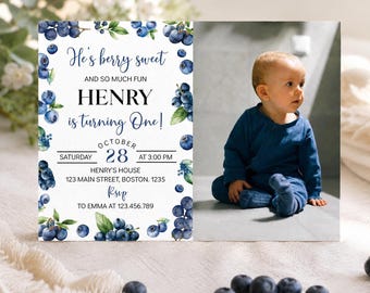 May include: A rectangular birthday invitation card featuring a watercolor blueberry border and a photograph of a baby in a blue outfit. The text reads: He's berry sweet AND SO MUCH FUN HENRY is turning One! OCTOBER 28 SATURDAY AT 3:00 PM.