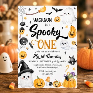 May include: A white Halloween-themed birthday invitation card featuring watercolor illustrations of ghosts, pumpkins, bats, and candy. The text reads Jackson is a Spooky ONE, Join us to celebrate His 1st Boo-day, Sunday, October 30th, 5:00 PM, 123 Spooky Street, Ohio.