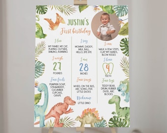 May include: A green, blue and orange illustrated first birthday poster featuring a photo of a baby boy. The poster has a dinosaur theme and lists the baby's milestones, including weight, height, favourite foods, songs and toys. The poster also includes the baby's name, Justin, and the text "First Birthday".