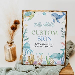 May include: A printable sign with a watercolor design of sea creatures, including a turtle, whale, jellyfish, and coral. The sign says "Fully editable CUSTOM SIGN TYPE YOUR OWN TEXT CREATE MULTIPLE SIGNS."
