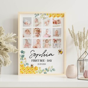 May include: A framed photo collage print featuring twelve baby portraits arranged in a grid. The design includes watercolor illustrations of honeycombs, bees, and flowers. The text reads Sophia, FIRST BEE - DAY, and the date 22.09.202X in black font.