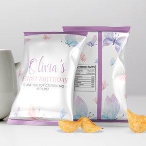 May include: Purple and white chip bag with a butterfly design and the text "Olivia's First Birthday Thank You for Celebrating with Me!" printed on the front.