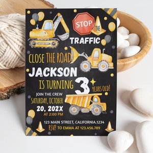 May include: A rectangular birthday invitation card with a black chalkboard background featuring yellow construction vehicles, orange traffic cones, and balloons. The text reads: STOP THE TRAFFIC, CLOSE THE ROAD, JACKSON IS TURNING 3 YEARS OLD!