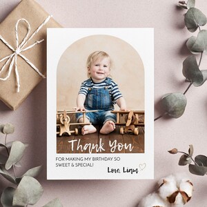 May include: A thank you card with a photo of a young child sitting on a wooden floor with toy airplanes. The card has the text "Thank you for making my birthday so sweet & special! Love, Liam" with a heart.