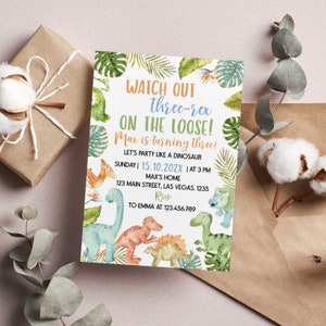 May include: A rectangular birthday invitation card featuring watercolor illustrations of various dinosaurs and tropical leaves. The text reads: WATCH OUT three-rex ON THE LOOSE! Max is turning three! LET'S PARTY LIKE A DINOSAUR SUNDAY | 15.10.202X | AT 3 PM MAX'S HOME 123 MAIN STREET, LAS VEGAS. 1235 RSVP TO EMMA AT 123.456.789