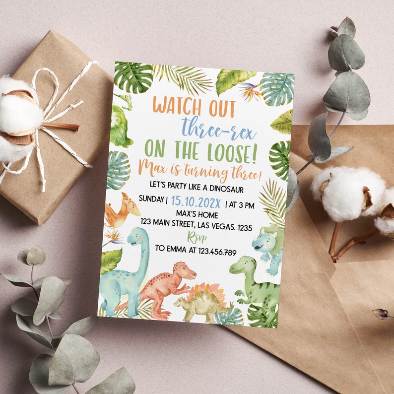 May include: A rectangular birthday invitation card featuring watercolor illustrations of various dinosaurs and tropical leaves. The text reads: WATCH OUT three-rex ON THE LOOSE! Max is turning three! LET'S PARTY LIKE A DINOSAUR SUNDAY | 15.10.202X | AT 3 PM MAX'S HOME 123 MAIN STREET, LAS VEGAS. 1235 RSVP TO EMMA AT 123.456.789