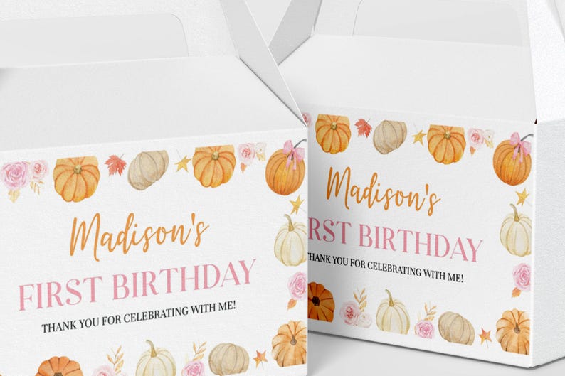 May include: Two white cardboard gable boxes featuring a watercolor design of orange and white pumpkins, pink roses, and autumn leaves. The text reads Madison's FIRST BIRTHDAY THANK YOU FOR CELEBRATING WITH ME! in orange and pink lettering.