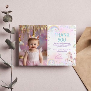May include: A rectangular thank you card featuring a photo of a child wearing a gold unicorn horn headband on the left and a pastel-colored design with rainbows, clouds, stars, and a unicorn illustration on the right with the text Thank You.