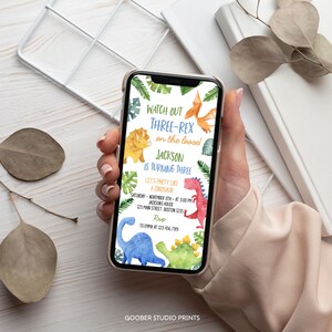 May include: A digital invitation for a dinosaur themed birthday party. The invitation features a blue, green, and red dinosaur with the text "Watch out Three-Rex on the loose! Jackson is turning three. Let's party like a dinosaur. Saturday, November 11th at 3:00 PM. Jackson's House, 123 Main Street, Boston 1235. RSVP to Emma at 123.456.789."