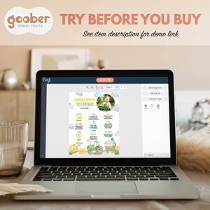 May include: A laptop screen displaying a digital design template for a first birthday party. The design features a tractor, a baby photo, and a list of milestones. The text "JACKSON'S FIRST BIRTHDAY" is at the top of the design. The text "TRY BEFORE YOU BUY" is displayed at the top of the laptop screen.