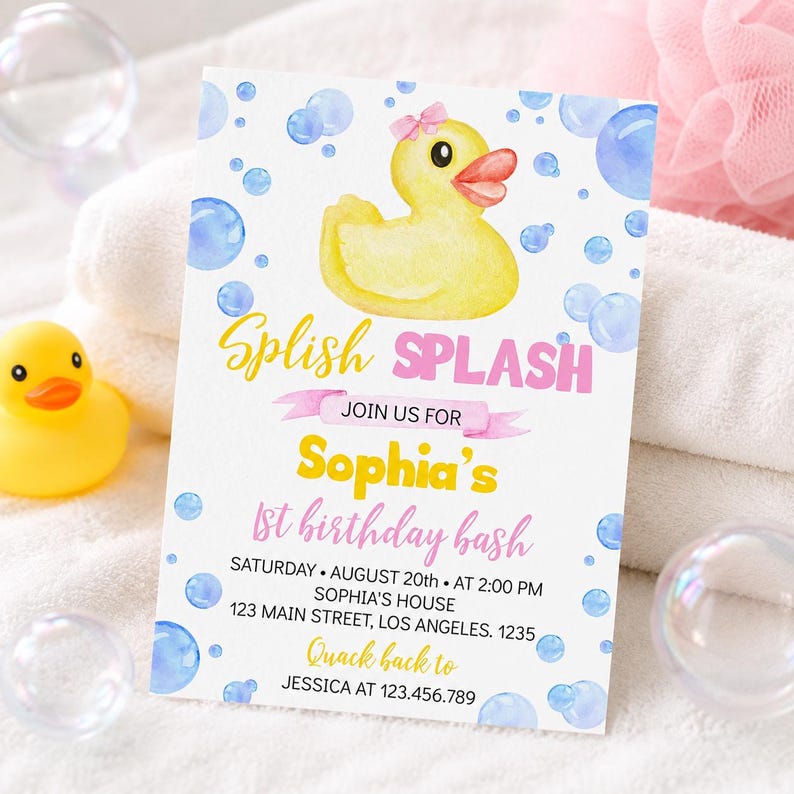 May include: A rectangular birthday invitation card featuring a yellow rubber duck with a pink bow, blue watercolor bubbles, and the text Splish Splash, Join Us For, Sophia's 1st Birthday Bash, Saturday August 20th at 2:00 PM, Sophia's House, 123 Main Street, Los Angeles 1235, Quack back to Jessica at 123.456.789.