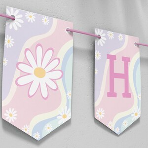 May include: A decorative banner featuring rectangular pennants strung on a pink cord. Each pennant displays a pastel wavy background with white daisy flowers and yellow centers. One pennant shows a large daisy, while others display the letters H and A.