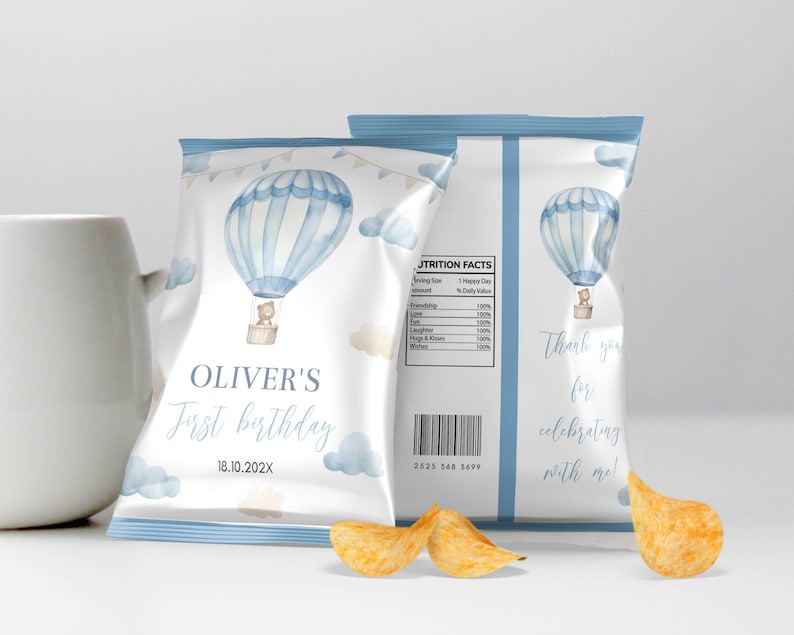 May include: Customizable chip bag design for a first birthday celebration. The design features a watercolor hot air balloon with a teddy bear, clouds, and the text "Oliver's First Birthday". The bag also includes the date 18.10.202X and a thank you message.