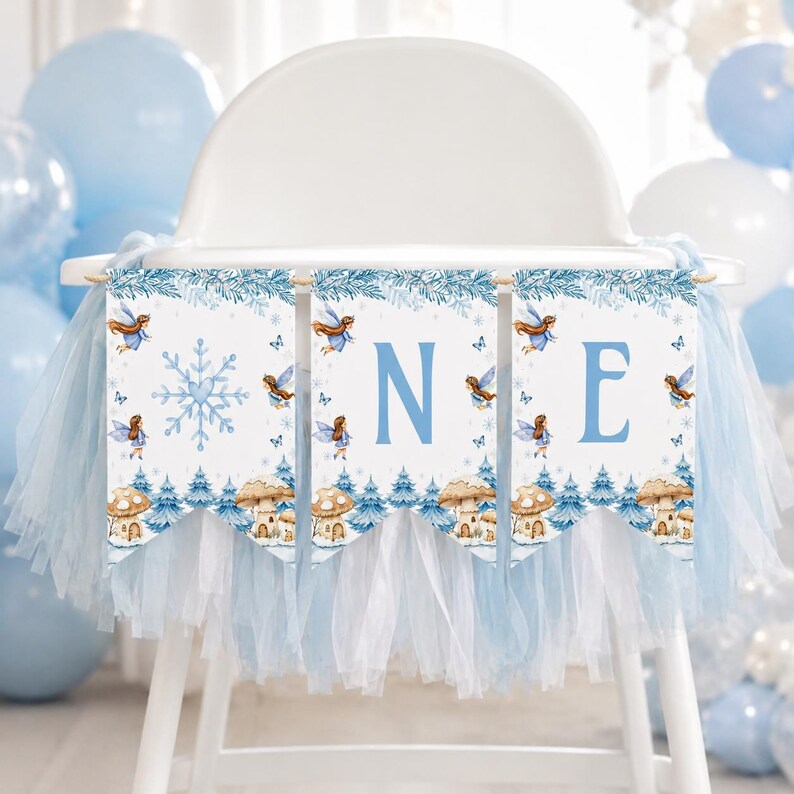 May include: A high chair banner featuring three white pennants with blue tulle trim. The design includes watercolor illustrations of fairies, blue snowflakes, and mushrooms. The letters O, N, and E are printed in large blue font across the pennants.
