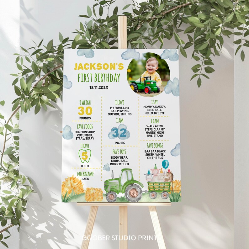 May include: A colorful first birthday poster for a boy named Jackson. The poster features a tractor, farm animals, and a photo of the birthday boy. It includes details about his age, weight, height, favorite foods, toys, and songs. The poster is decorated with clouds, sunflowers, and hay bales.