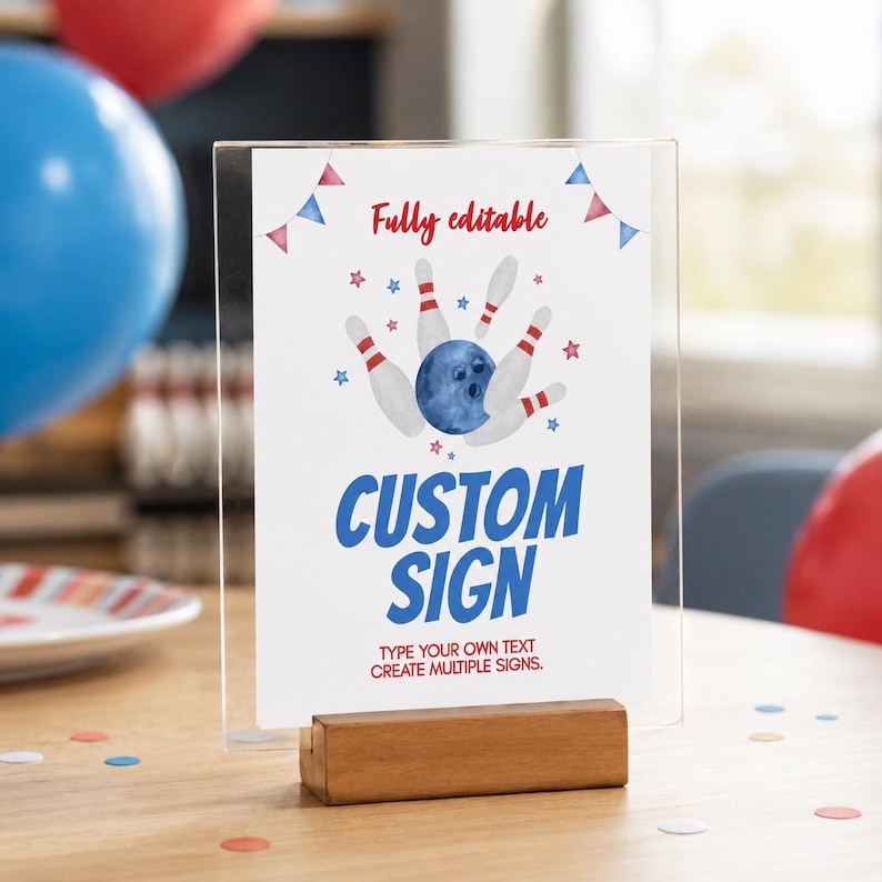 May include: A clear acrylic sign holder with a wooden base displaying a white card with a watercolor bowling theme. The card features red and blue bunting, bowling pins, a blue bowling ball, and red stars with the text Fully editable, CUSTOM SIGN, and TYPE YOUR OWN TEXT CREATE MULTIPLE SIGNS.