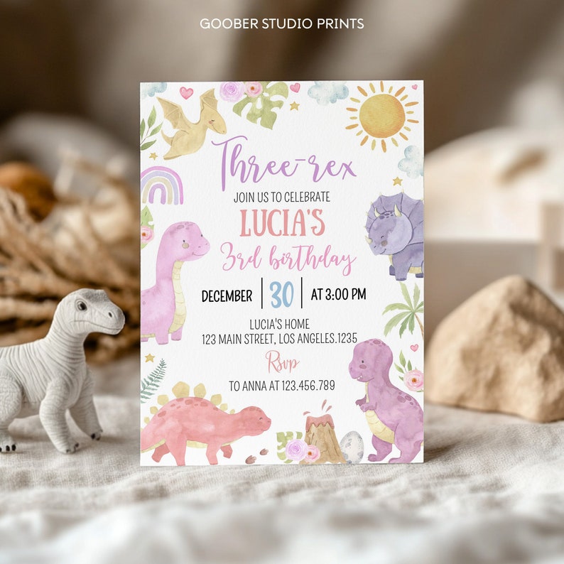 May include: A rectangular birthday invitation card featuring watercolor illustrations of dinosaurs, a sun, a rainbow, and flowers. The text reads Three-rex, Join us to celebrate Lucia's 3rd birthday, December 30 at 3:00 PM, Lucia's home, 123 Main Street, Los Angeles.1235, RSVP to Anna at 123.456.789.