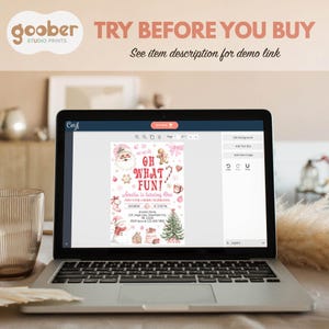 May include: A laptop displays a Christmas-themed invitation design with Santa Claus, gingerbread men, and a Christmas tree. The text on the invitation reads "OH WHAT FUN!" and "Amelia is turning One." The laptop is open on a table with the text "TRY BEFORE YOU BUY".