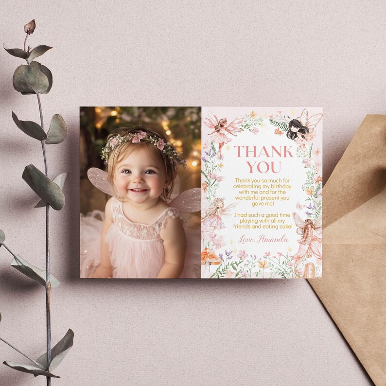 May include: A pink thank you card with a floral border and a photo of a young girl dressed as a fairy. The text on the card reads "Thank you so much for celebrating my birthday with me and for the wonderful present you gave me! I had such a good time playing with all my friends and eating cake! Love, Amanda."