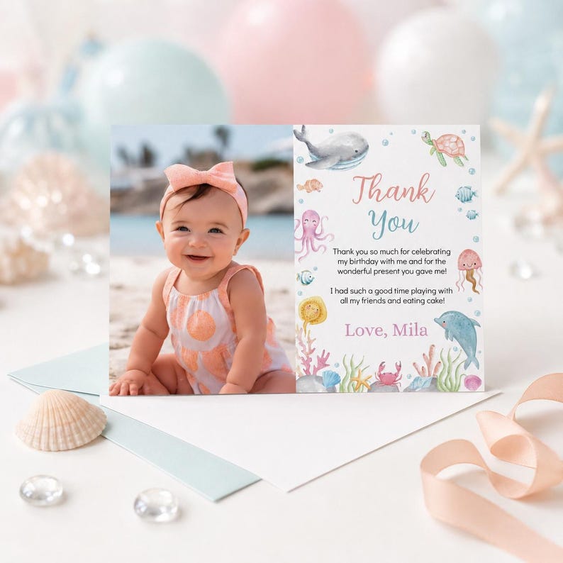 May include: A rectangular thank you card featuring a photo of a smiling baby wearing a peach-colored outfit and headband on the left. The right side displays watercolor sea creatures, the text Thank You, and a message signed by Mila.