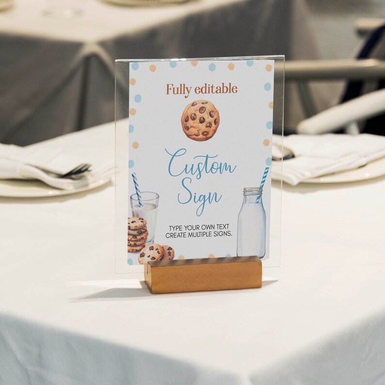 May include: A printable sign with a blue and white polka dot background. The sign features a cartoon cookie with chocolate chips, a glass of milk, and the text "Fully editable Custom Sign Type your own text Create multiple signs."