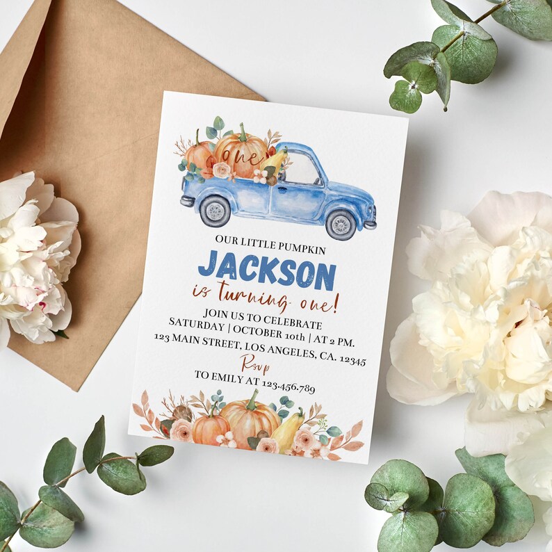 May include: A rectangular birthday invitation card featuring a watercolor illustration of a blue pickup truck carrying pumpkins and flowers. The text reads: OUR LITTLE PUMPKIN JACKSON is turning one! JOIN US TO CELEBRATE SATURDAY | OCTOBER 10th | AT 2 PM. 123 MAIN STREET, LOS ANGELES, CA. 12345 RSVP TO EMILY AT 123-456-789.