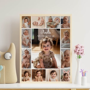 May include: A collage of photos of a baby girl, with the text "Amelia, My First Year" in the center. The photos are arranged in a grid pattern, with a wooden frame.