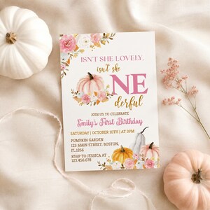 May include: A rectangular birthday invitation card featuring pink and white floral illustrations, a light pink pumpkin, and the text: ISN'T SHE LOVELY, isn't she ONE derful, JOIN US TO CELEBRATE Emily's First Birthday, SATURDAY | OCTOBER 10TH | AT 3PM.