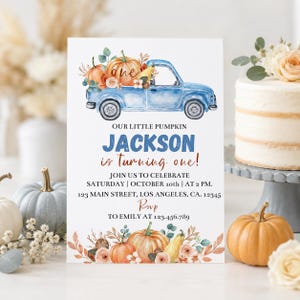 May include: A white birthday invitation card featuring a watercolor blue pickup truck carrying pumpkins and flowers. Text reads: OUR LITTLE PUMPKIN JACKSON is turning one! JOIN US TO CELEBRATE SATURDAY | OCTOBER 10th | AT 2 PM. 123 MAIN STREET, LOS ANGELES, CA. 12345 RSVP TO EMILY AT 123.456.789.