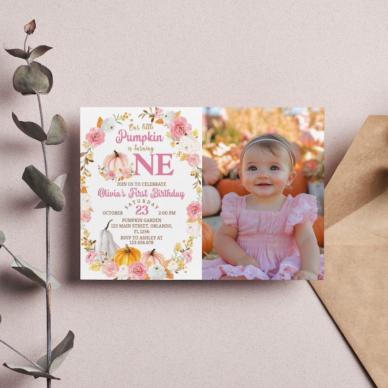 Pu&ograve; includere: Un invito al primo compleanno rosa e oro con una foto di una bambina in un vestito rosa. L'invito presenta una ghirlanda di foglie autunnali, zucche e fiori. Il testo sull'invito recita "La nostra piccola zucca compie un anno" e "Il primo compleanno di Olivia".