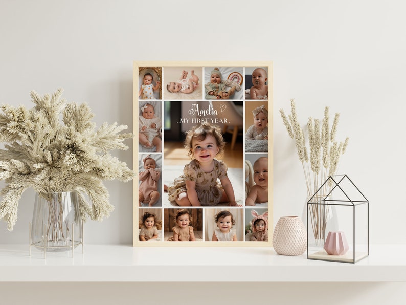 May include: A framed collage of photos of a baby girl, with the text "Amelia - My First Year." The collage is in a light wood frame and has a white background.