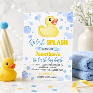 May include: A birthday invitation with a yellow rubber duck illustration and blue bubbles. The text reads "Splish Splash" and announces Jonathan's 1st birthday bash, including date, time, and location.