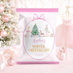 May include: A rectangular snack bag with a pink and white striped pattern. The center features an oval frame containing a Christmas tree, a ballerina, a nutcracker, and a rocking horse. Text reads: Sophia's WINTER ONEDERLAND 16.12.202X.