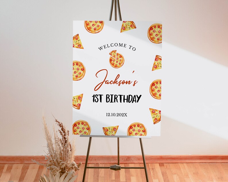 May include: White welcome sign with a pizza theme. The sign says "Welcome to Jackson's 1st Birthday 12.10.202X". The sign is decorated with watercolor illustrations of pizzas and pizza slices.