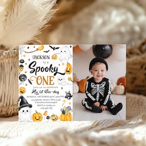 May include: A Halloween-themed invitation with the text "Jackson is a Spooky One" and a photo of a baby in a skeleton costume. The invitation includes details for a first birthday party, with pumpkins and ghosts.