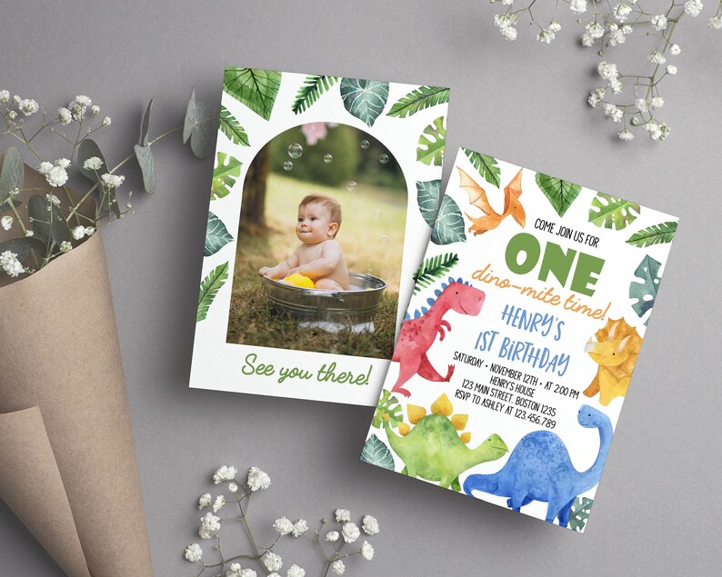 May include: Two rectangular birthday invitation cards featuring watercolor dinosaur illustrations and tropical leaves. One card displays a photo of a child in a tub with the text See you there. The other card reads Come join us for ONE dino-mite time! Henry's 1st Birthday.