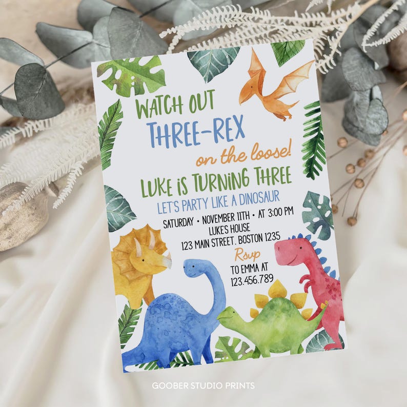 May include: A birthday party invitation with a dinosaur theme. The invitation features colorful watercolor illustrations of dinosaurs and tropical leaves. Text includes "Watch Out Three-Rex", "Luke is Turning Three", and party details.