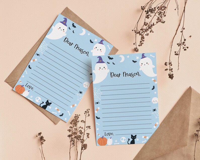 May include: Two light blue stationery sheets with lined writing space, each featuring the printed text Dear Mason and Love. The design includes cartoon ghosts wearing purple hats, black cats, orange pumpkins, white skulls, bats, and spiderwebs.