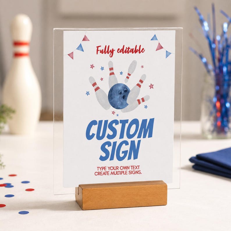 May include: A clear acrylic sign holder with a wooden base displaying a white card with red and blue bowling-themed graphics. The text reads Fully editable, CUSTOM SIGN, and TYPE YOUR OWN TEXT CREATE MULTIPLE SIGNS in red and blue lettering.
