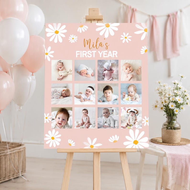 May include: A pink milestone board featuring white daisy illustrations and the text Mila's FIRST YEAR. The board displays a grid of twelve photographs of an infant at different stages, set on a wooden easel with balloons and flowers nearby.