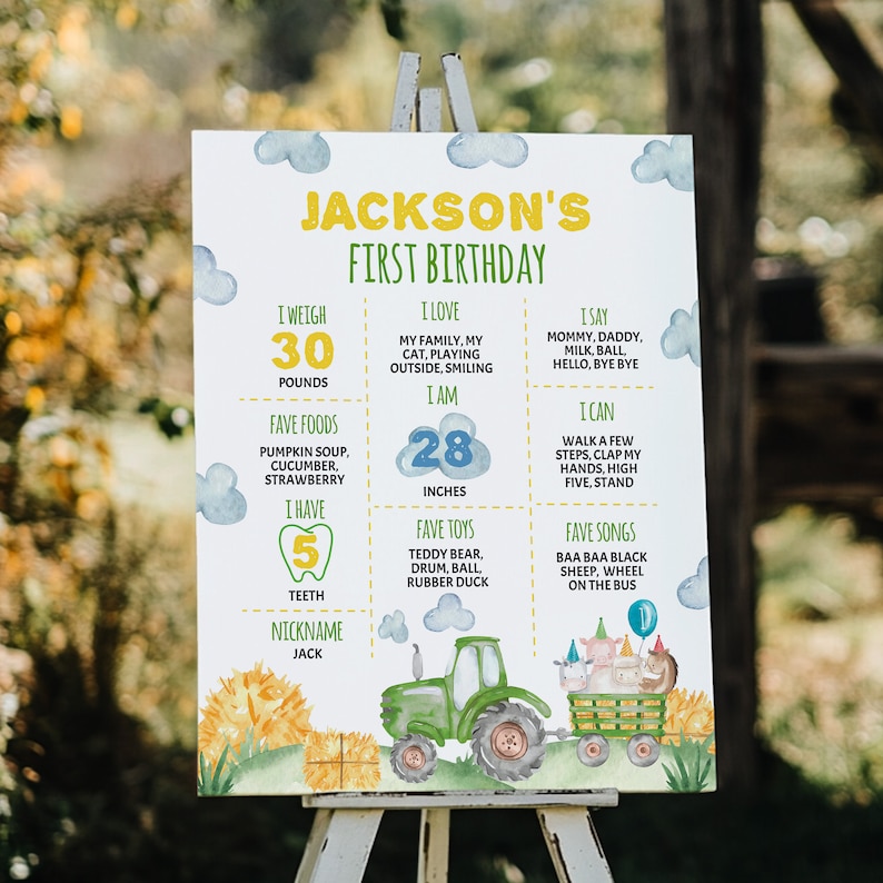 May include: A white birthday milestone sign for Jackson featuring a green tractor pulling a wagon with farm animals, blue watercolor clouds, and yellow text. It lists stats including 30 pounds, 28 inches, 5 teeth, favorite foods, toys, and songs.