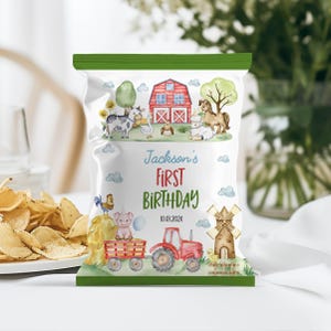 May include: A white snack bag with green top and bottom borders featuring watercolor farm illustrations including a red barn, a tractor, a windmill, and various farm animals. The text reads Jackson's FIRST BIRTHDAY and 10.01.202X.