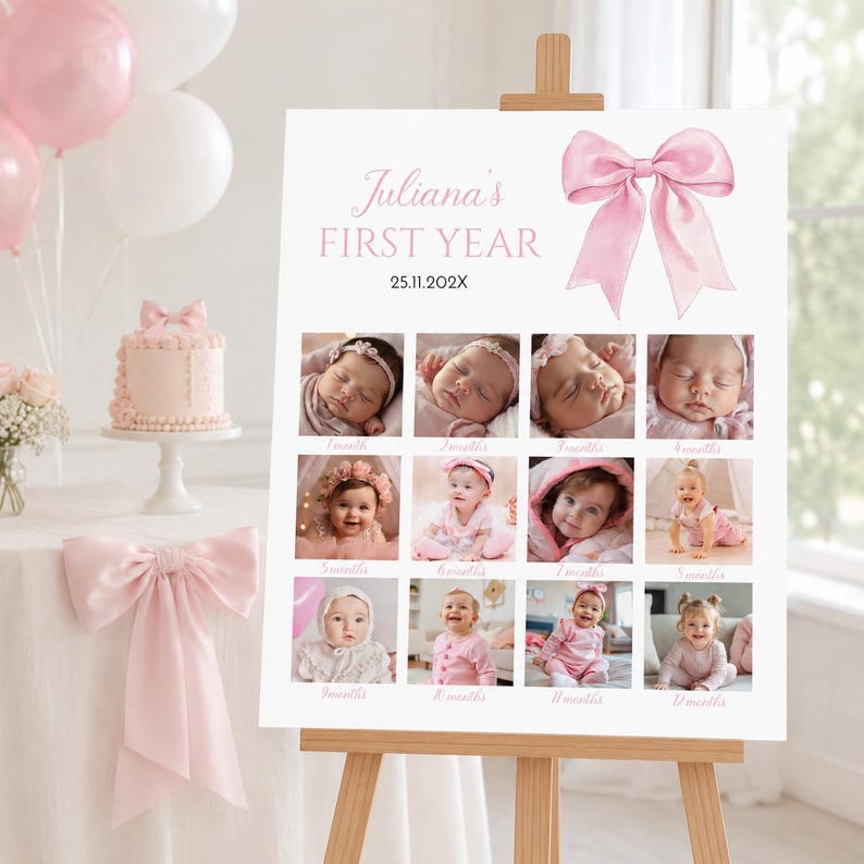 May include: A white milestone board titled Juliana's FIRST YEAR with the date 25.11.202X, featuring a large pink bow graphic and twelve square photographs documenting a baby's growth from one to twelve months, displayed on a wooden easel.